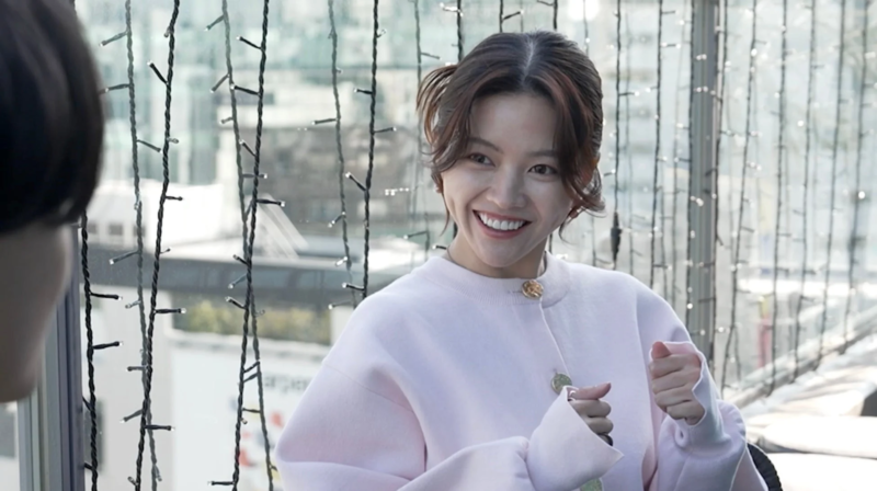 ピンクの服で笑顔の女性